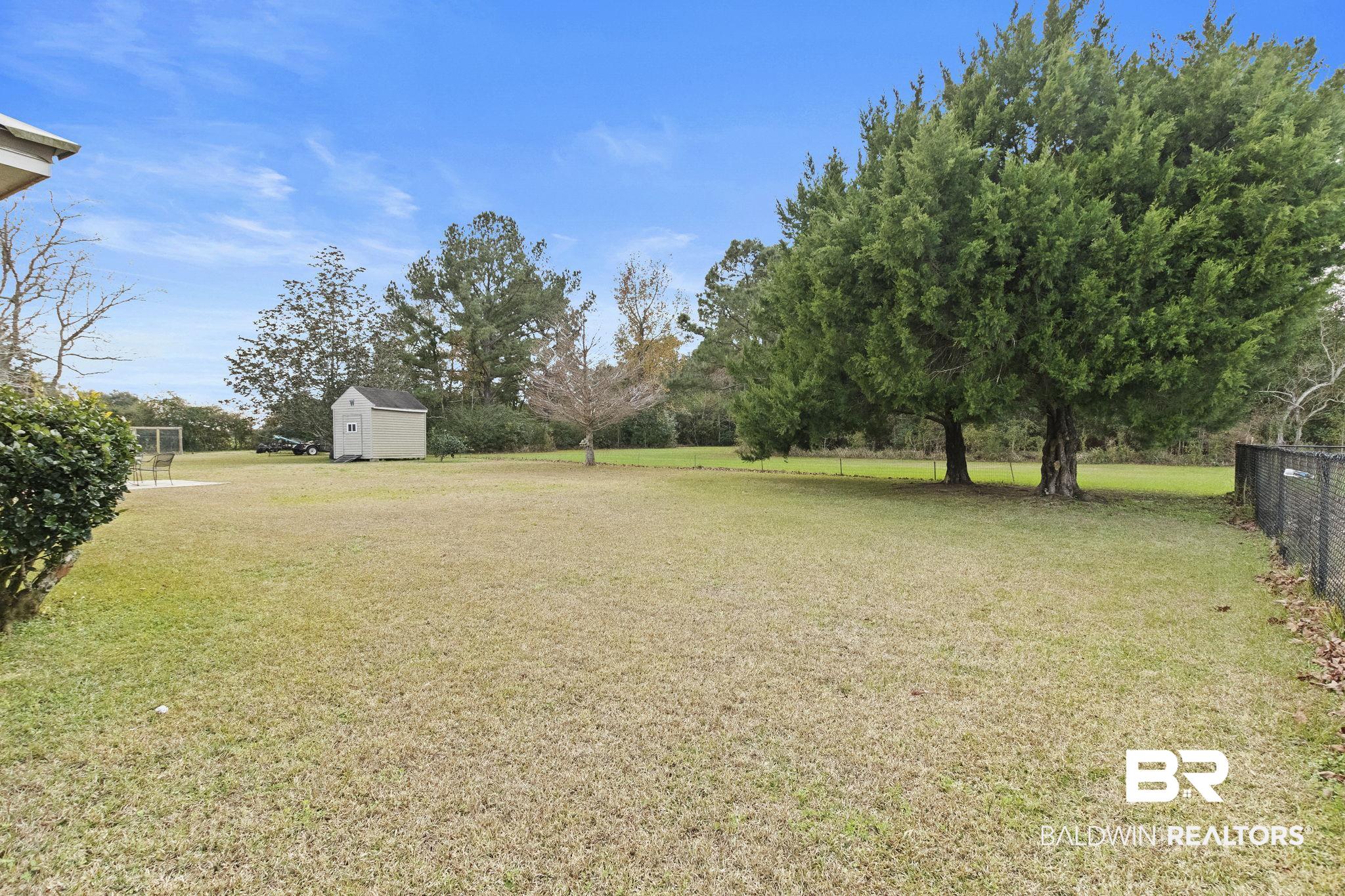 14031 Brook Hollow Road Summerdale, AL 36580 - Photo 50 of 56 View of yard featuring a storage unit