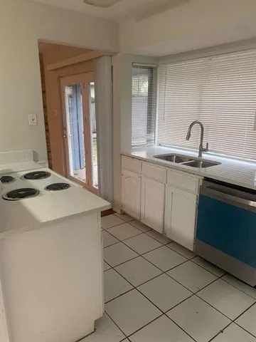 a kitchen with a sink and a stove top oven