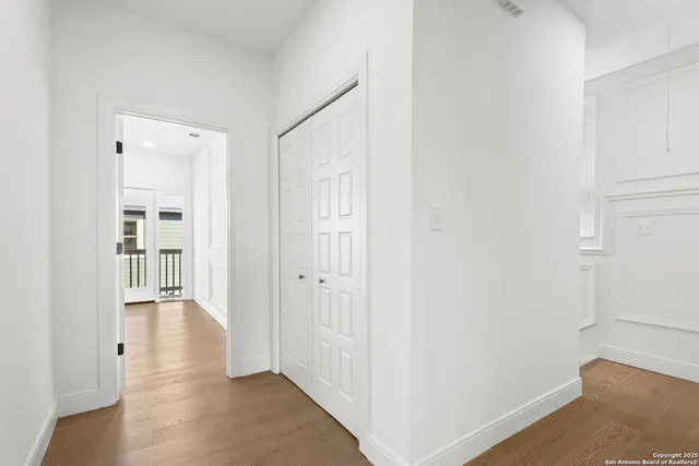 a view of hallway with wooden floor