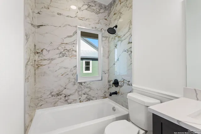 a bathroom with a bathtub and shower