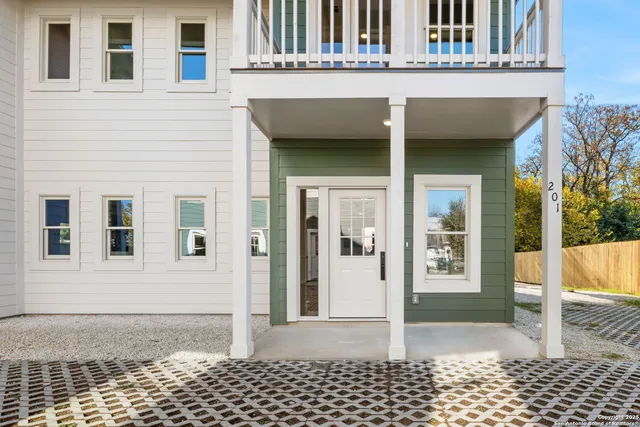 a view of a house with wooden fence