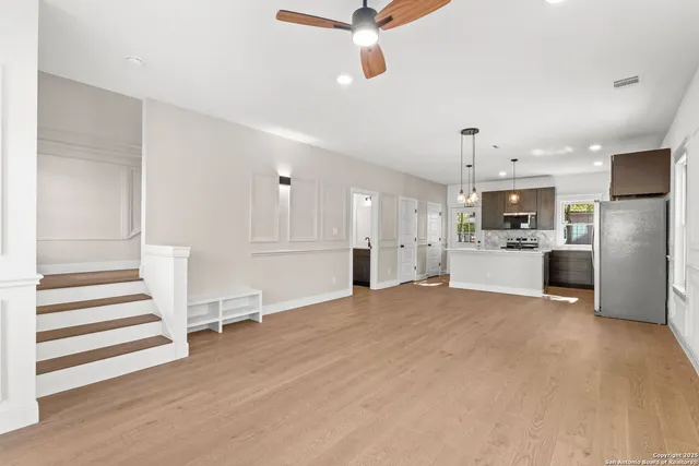 a view of kitchen with furniture and refrigerator