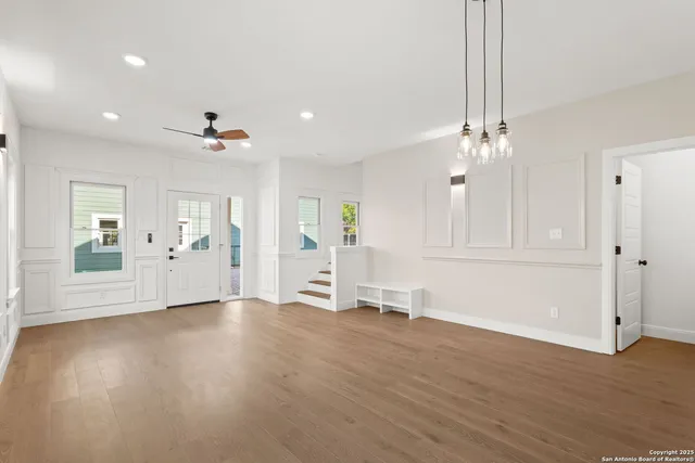 a view of an empty room with wooden floor