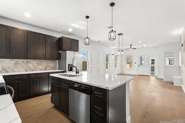 a kitchen with a sink cabinets and wooden floor
