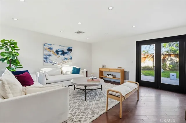 a living room with furniture and a floor to ceiling window