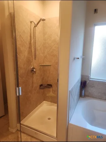 a bathroom with a tub and shower