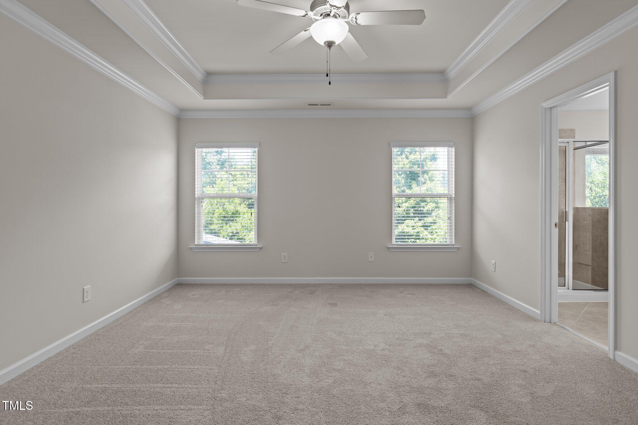 2082 Weston Green Loop Cary, NC 27513 - Photo 25 of 49 an empty room with windows and chandelier fan