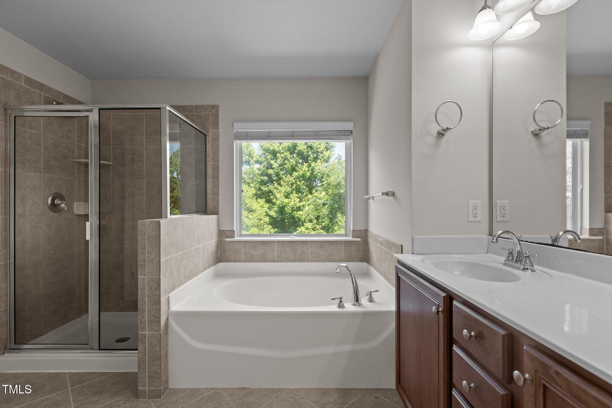 2082 Weston Green Loop Cary, NC 27513 - Photo 32 of 49 a bathroom with a tub sink and shower