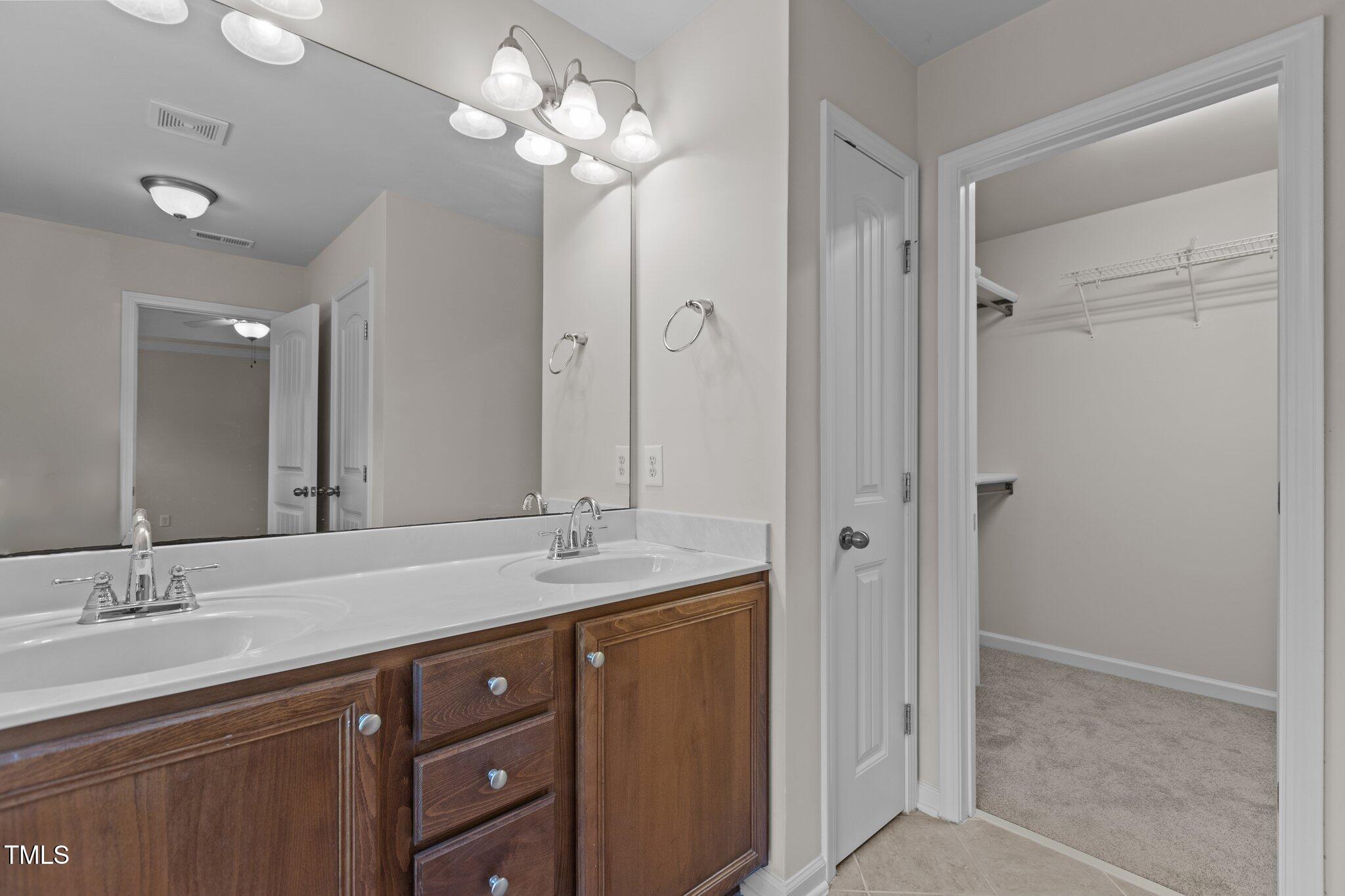 2082 Weston Green Loop Cary, NC 27513 - Photo 33 of 49 a bathroom with a granite countertop sink a mirror and a shower