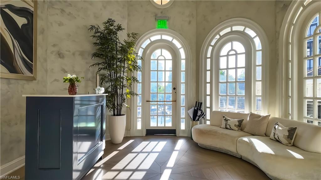 8169 Via Vecchia Naples, FL 34108 - Photo 22 of 33 a living room with furniture and large windows