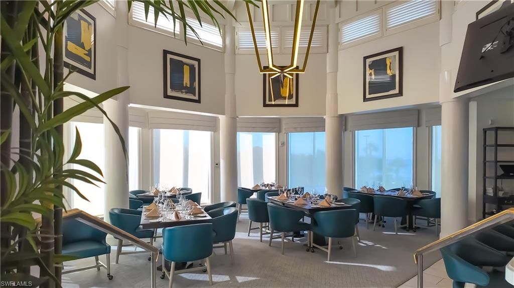 8169 Via Vecchia Naples, FL 34108 - Photo 23 of 33 a living room with furniture and floor to ceiling windows