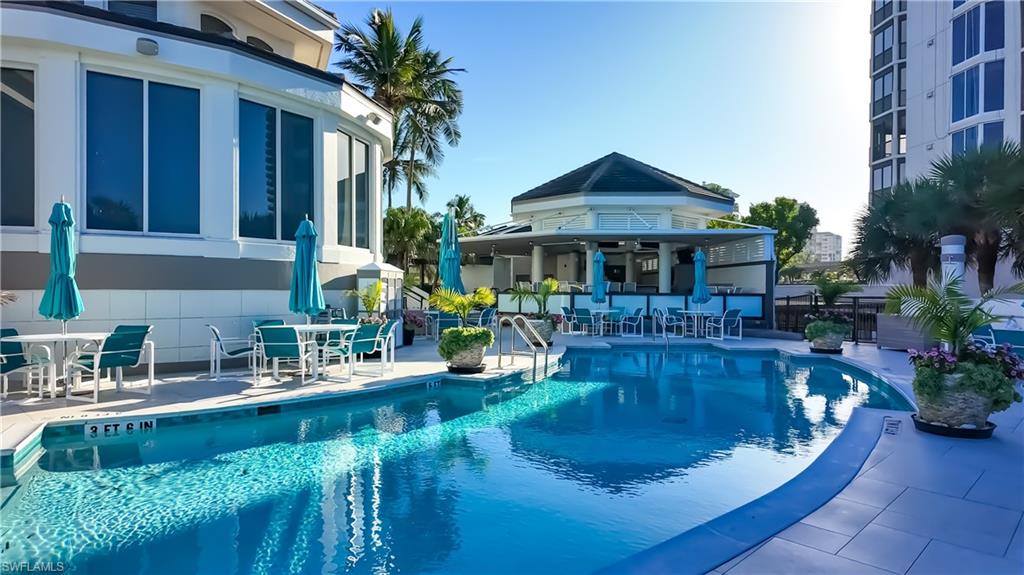 8169 Via Vecchia Naples, FL 34108 - Photo 25 of 33 a view of a house with pool and sitting area