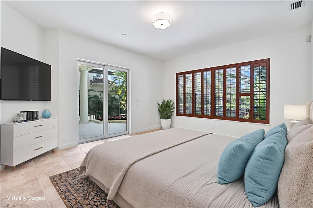 8169 Via Vecchia Naples, FL 34108 - Photo 8 of 33 a spacious bedroom with a bed and a flat screen tv