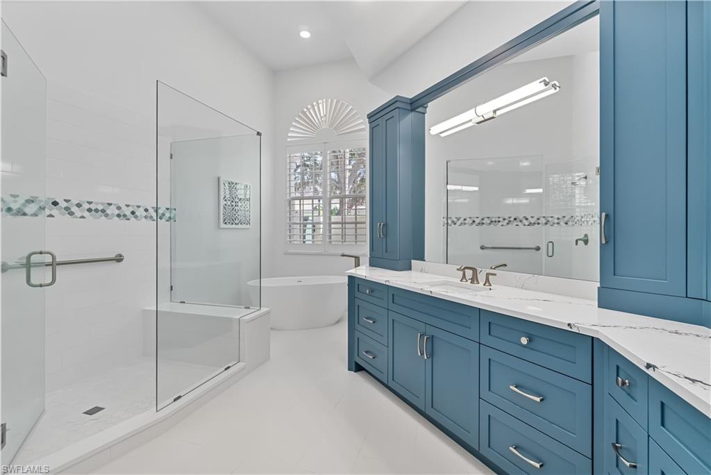 8169 Via Vecchia Naples, FL 34108 - Photo 9 of 33 a bathroom with a granite countertop sink mirror and shower