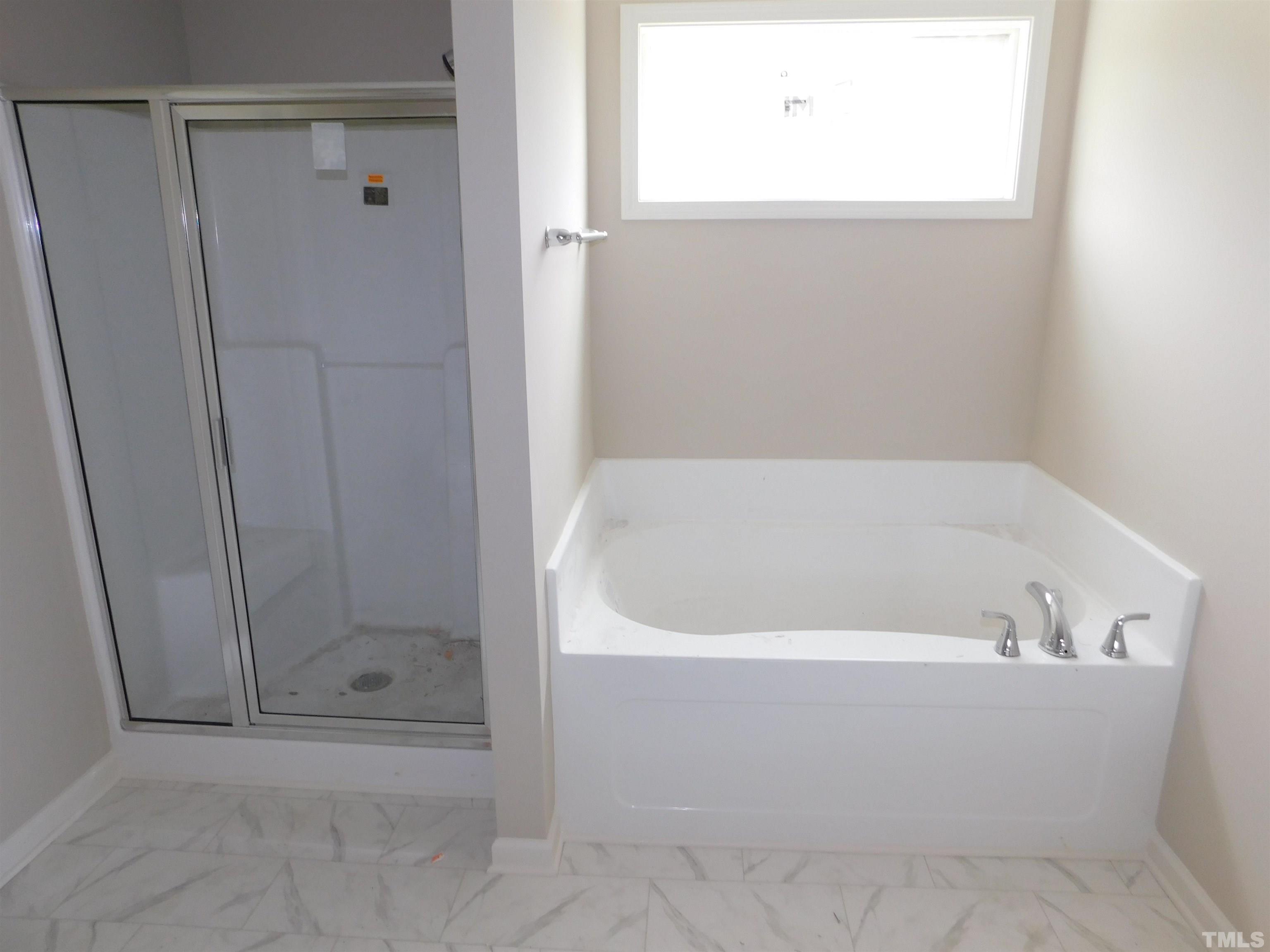 84 Kickoff Circle Benson, NC 27504 - Photo 12 of 21 a white bath tub sitting next to a shower