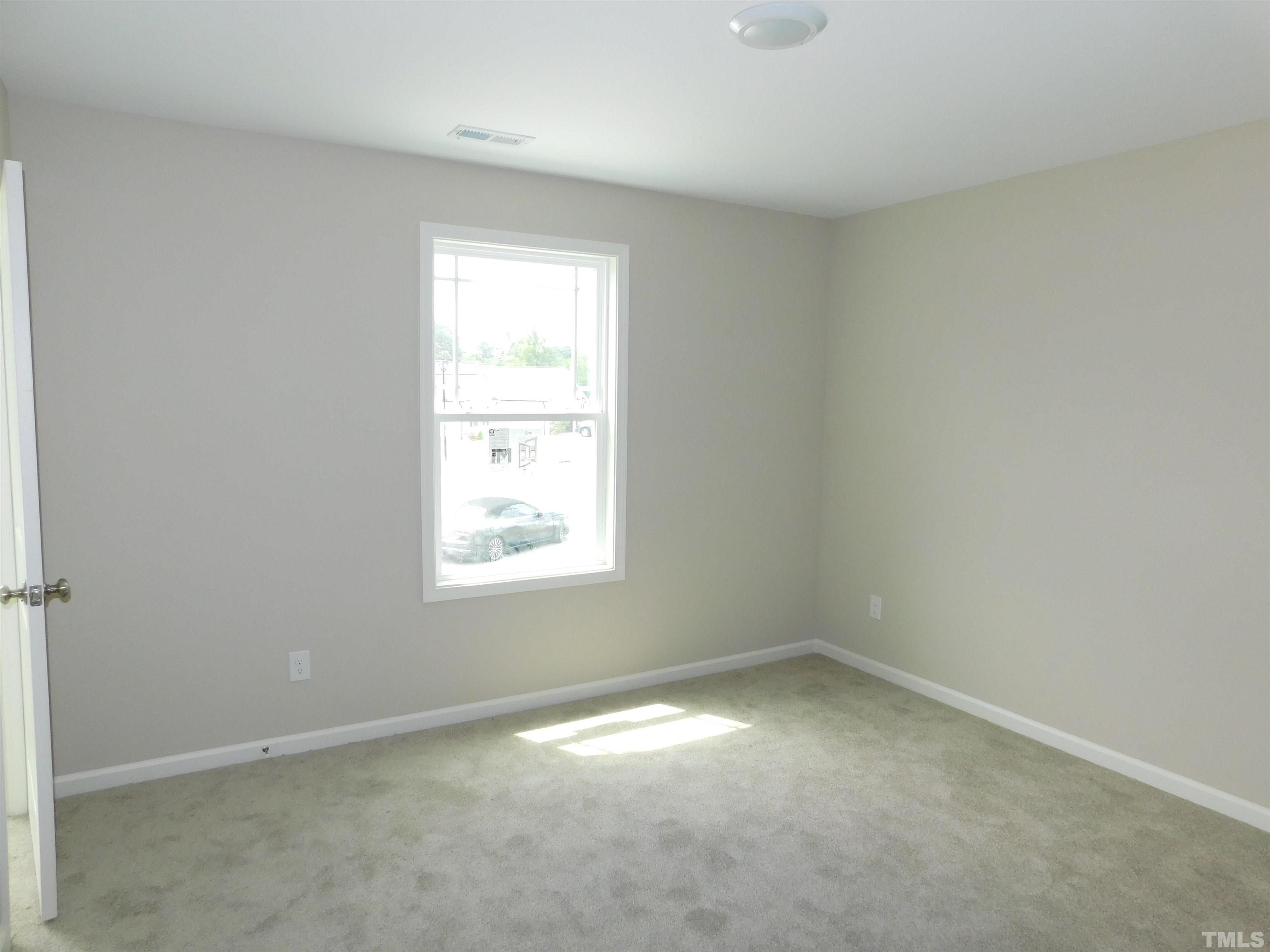 84 Kickoff Circle Benson, NC 27504 - Photo 17 of 21 an empty room with a window