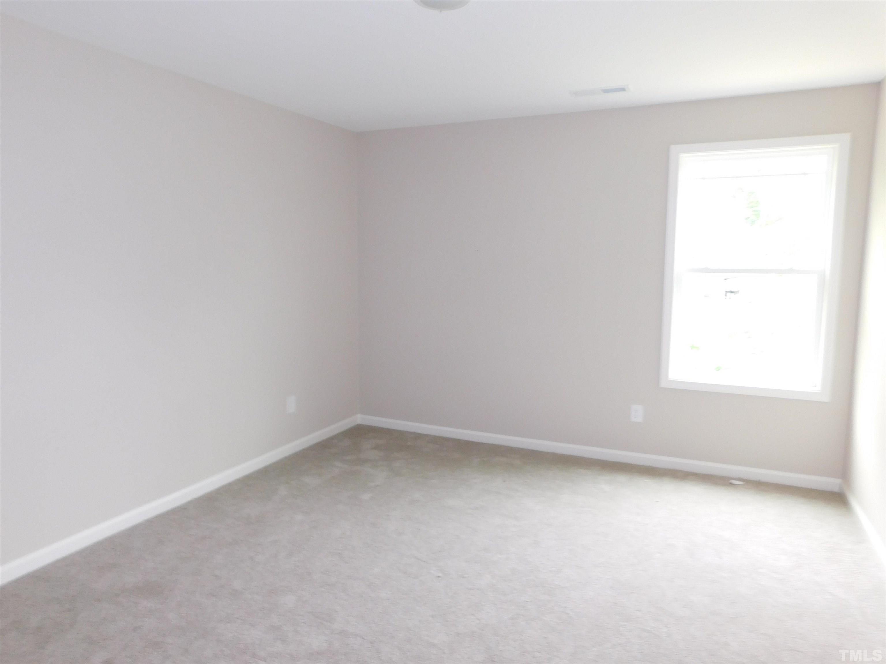 84 Kickoff Circle Benson, NC 27504 - Photo 19 of 21 an empty room with a window