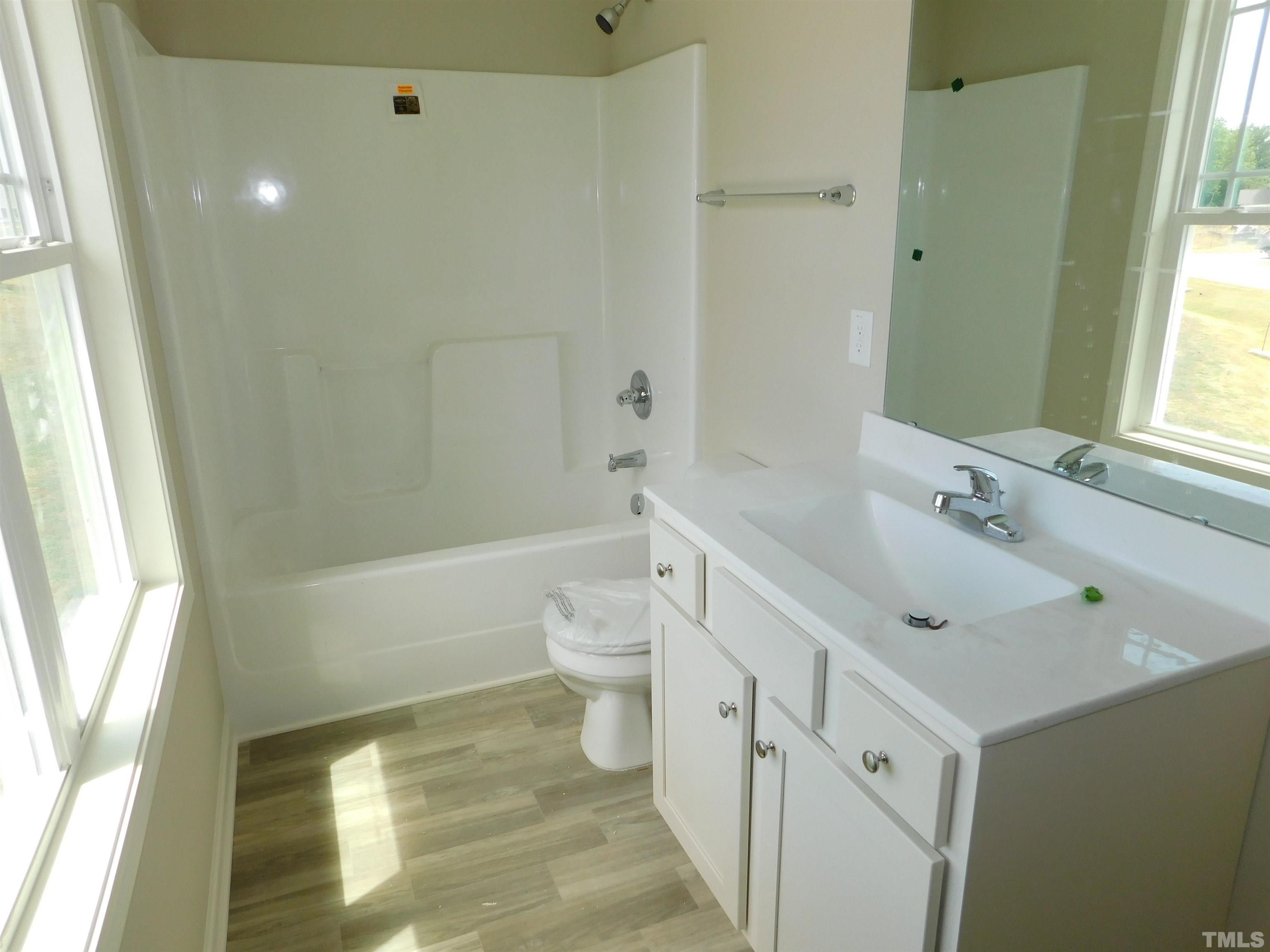 84 Kickoff Circle Benson, NC 27504 - Photo 20 of 21 a bathroom with a sink a toilet and shower
