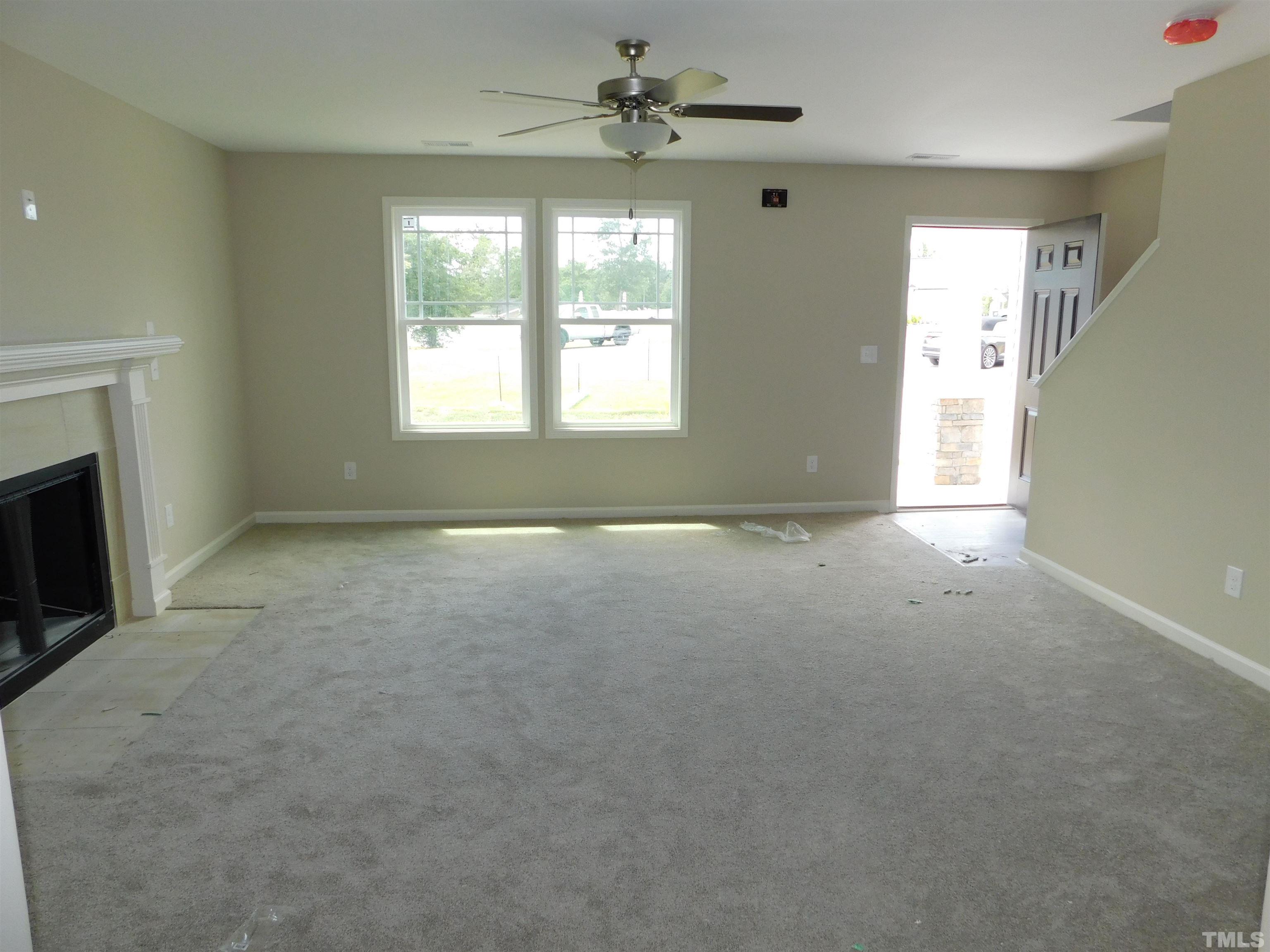 84 Kickoff Circle Benson, NC 27504 - Photo 3 of 21 an empty room with windows and fireplace