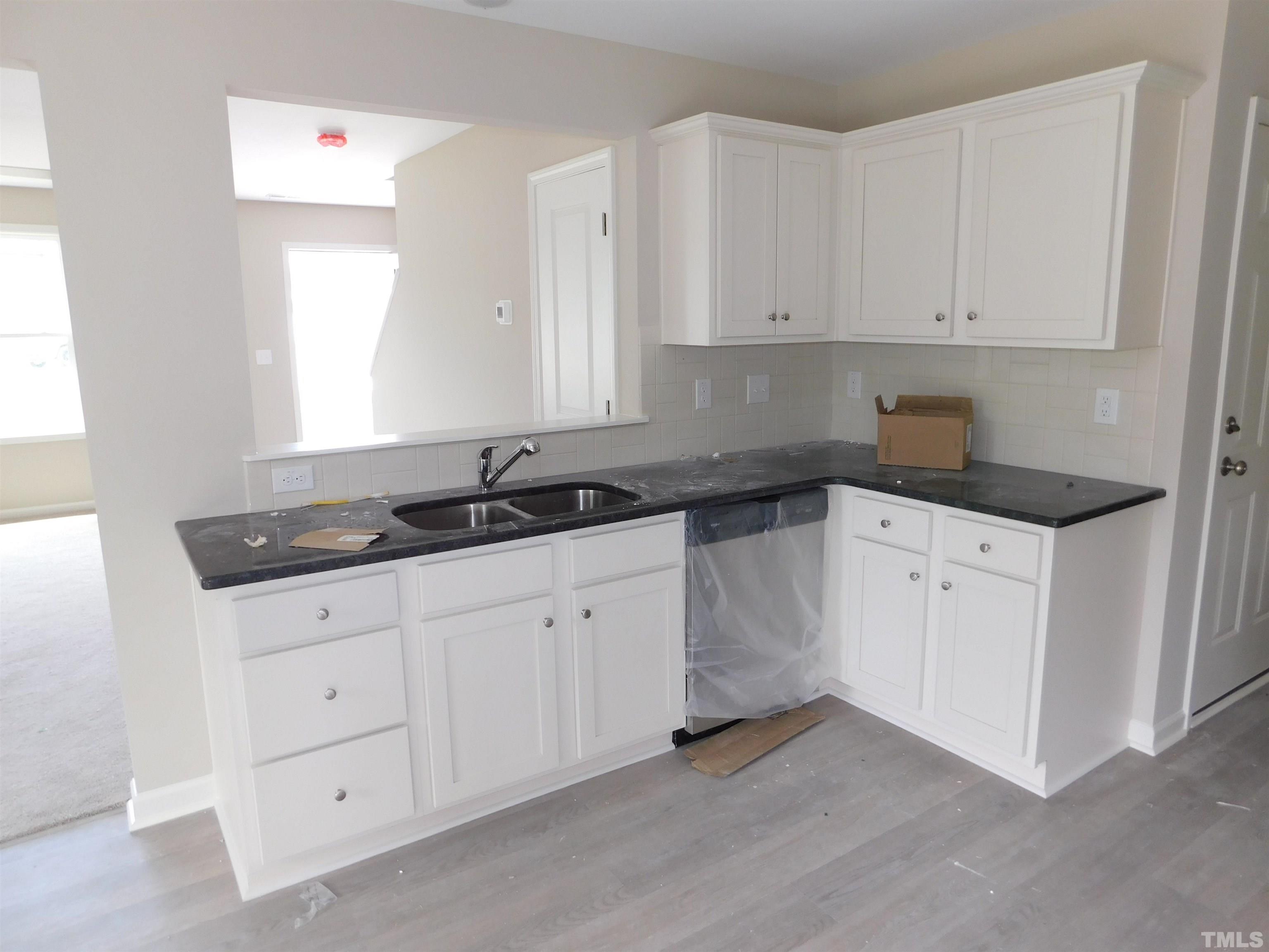 84 Kickoff Circle Benson, NC 27504 - Photo 6 of 21 a kitchen with white cabinets and a sink