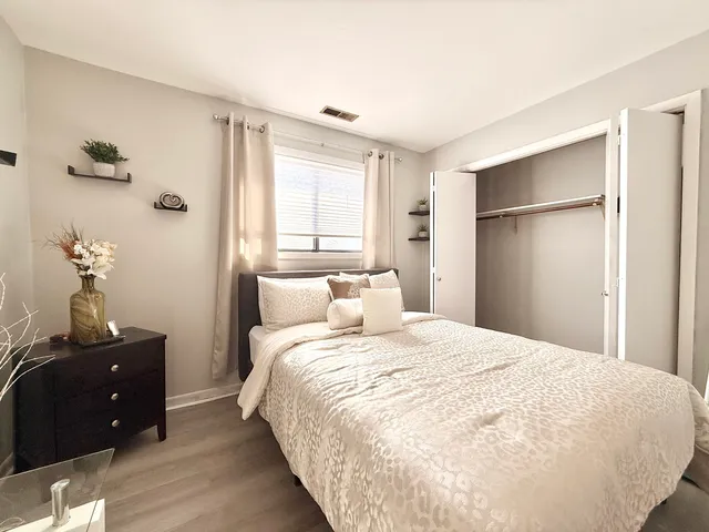 a bedroom with a bed and a closet