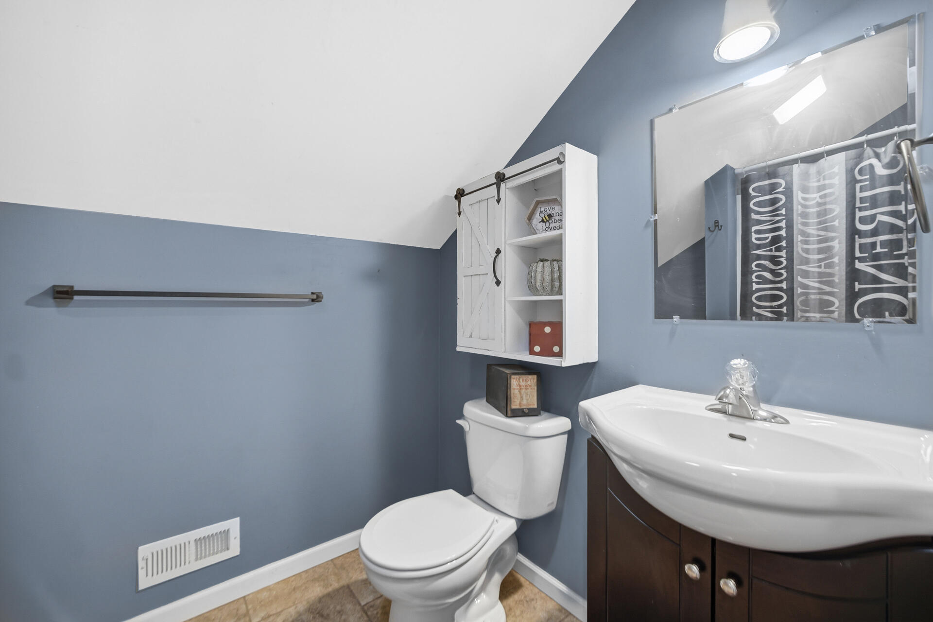 1913 Holly Street Southeast De Motte, IN 46310 - Photo 26 of 42 a bathroom with a sink mirror and toilet