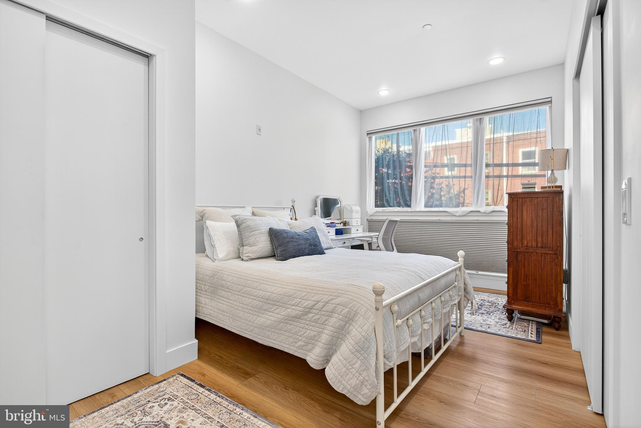 300 Christian Street, Unit 211 Philadelphia, PA 19147 - Photo 12 of 30 a bedroom with a bed and a table in it