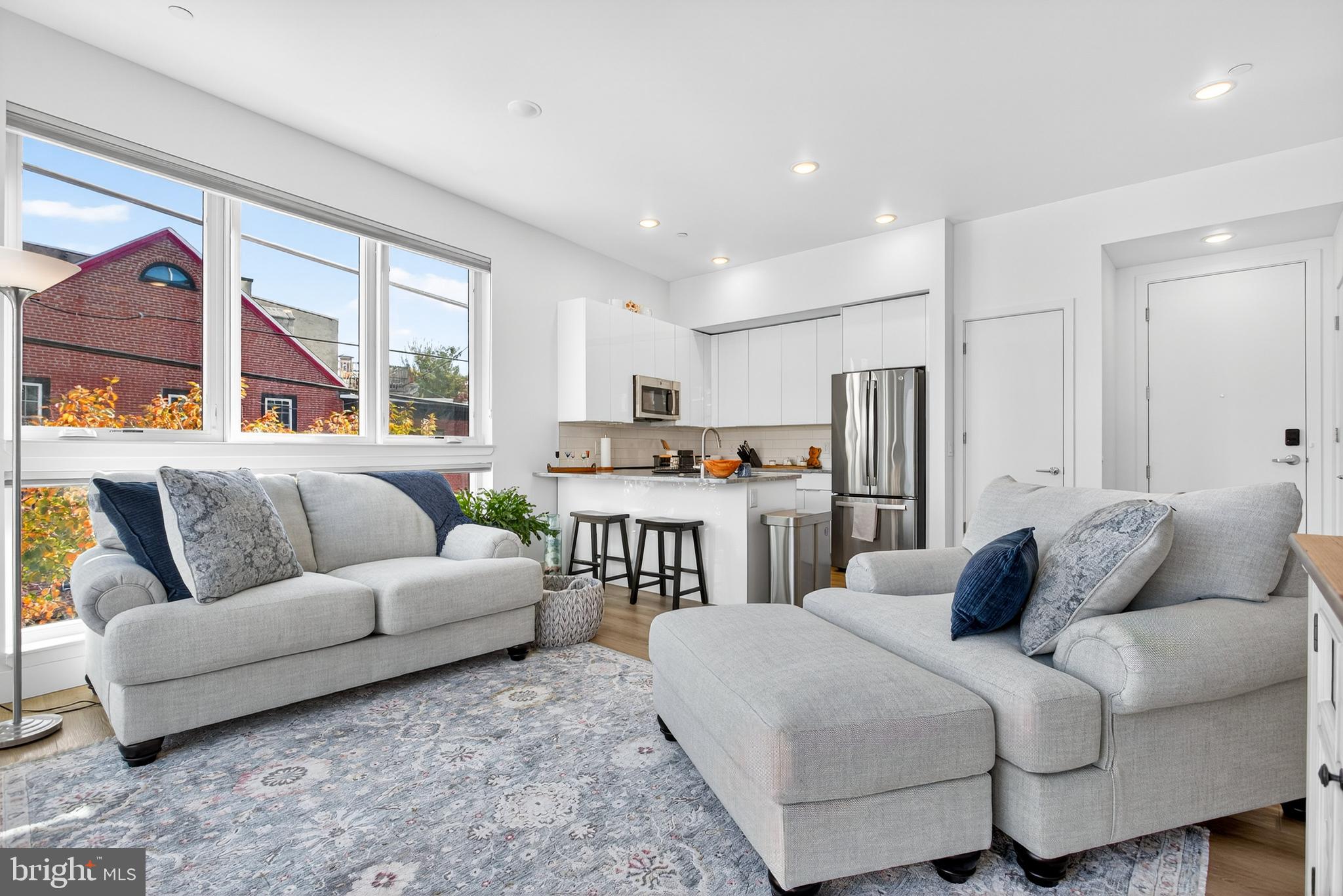 300 Christian Street, Unit 211 Philadelphia, PA 19147 - Photo 4 of 30 a living room with furniture and a large window