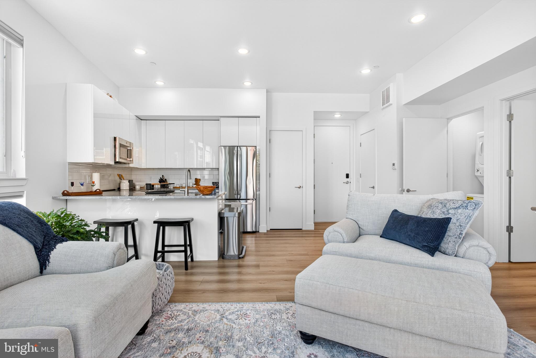 300 Christian Street, Unit 211 Philadelphia, PA 19147 - Photo 9 of 30 a living room with furniture and kitchen view