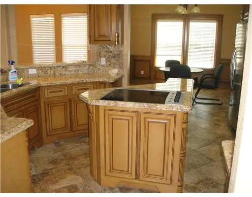 a kitchen with a stove a sink and a refrigerator