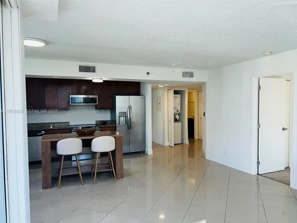 a dining room with furniture and a kitchen