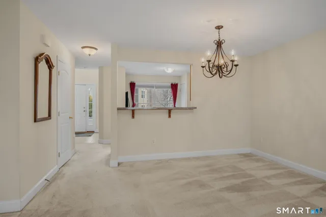 a view of a dining room with furniture and chandelier