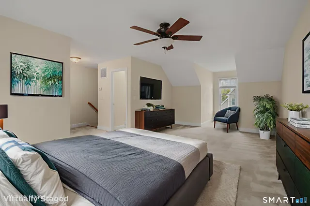 an empty room with windows and fan