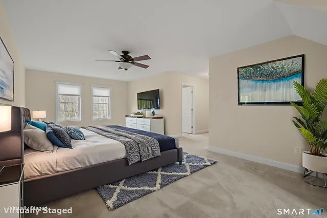 a view of an empty room with stairs and a cabinet