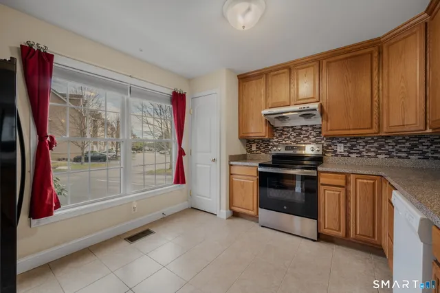 a kitchen with stainless steel appliances granite countertop a stove and a refrigerator