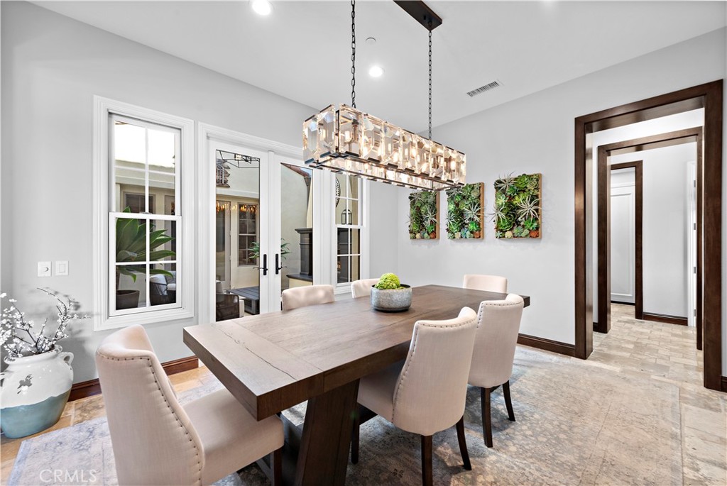 27 Pisano Street Ladera Ranch, CA 92694 - Photo 16 of 71 a view of a dining room with furniture wooden floor and chandelier