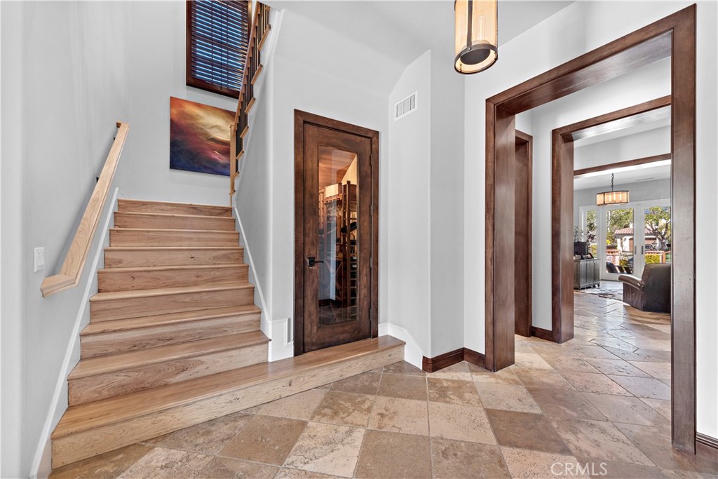 27 Pisano Street Ladera Ranch, CA 92694 - Photo 18 of 71 a view of a hallway with wooden floor and staircase