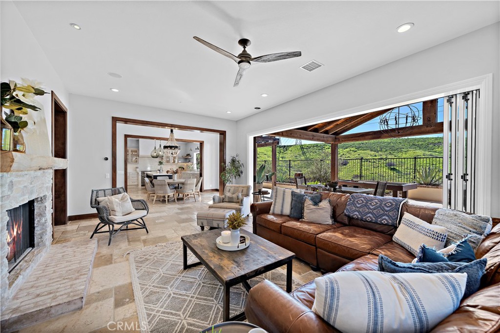27 Pisano Street Ladera Ranch, CA 92694 - Photo 21 of 71 a living room with furniture large window and a fireplace