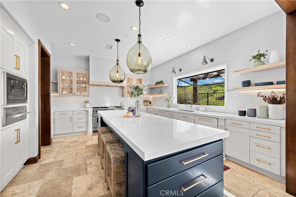 27 Pisano Street Ladera Ranch, CA 92694 - Photo 27 of 71 a kitchen with a stove a refrigerator and a sink