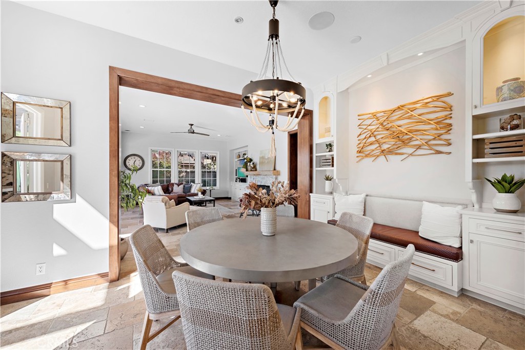 27 Pisano Street Ladera Ranch, CA 92694 - Photo 32 of 71 a dining room with wooden floor a chandelier a wooden table and chairs