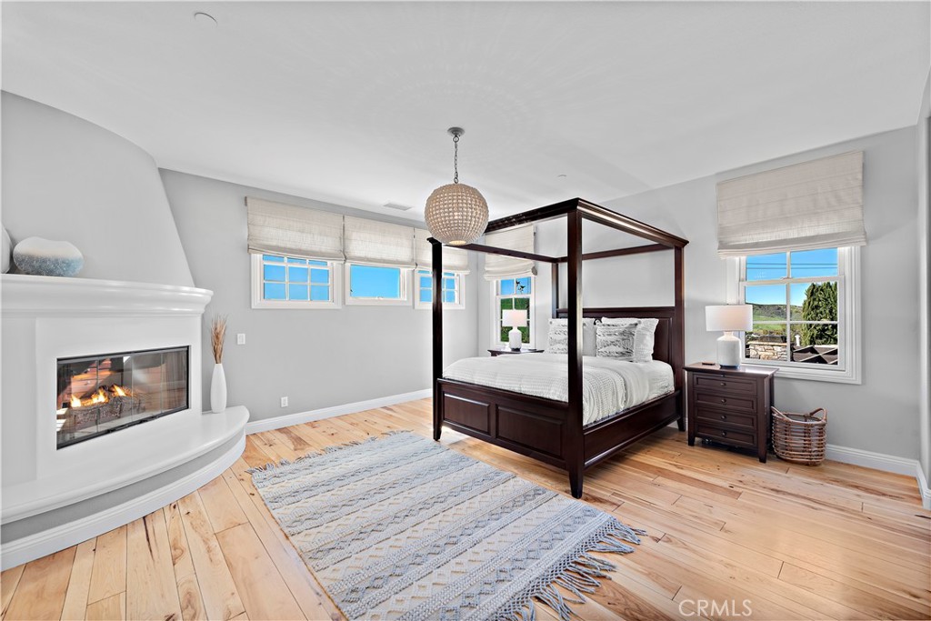27 Pisano Street Ladera Ranch, CA 92694 - Photo 33 of 71 a bedroom with a bed and a fireplace