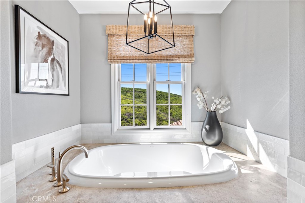 27 Pisano Street Ladera Ranch, CA 92694 - Photo 36 of 71 a bathroom with a tub and a window
