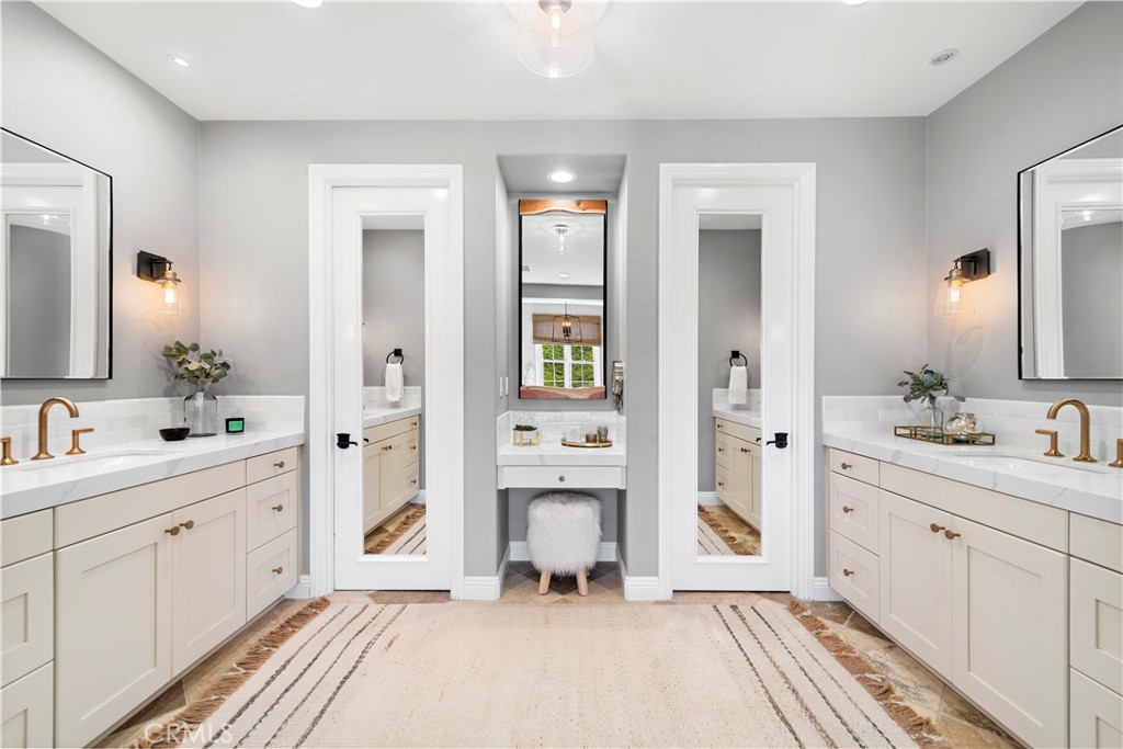 27 Pisano Street Ladera Ranch, CA 92694 - Photo 38 of 71 a spacious bathroom with a double vanity sink and a mirror