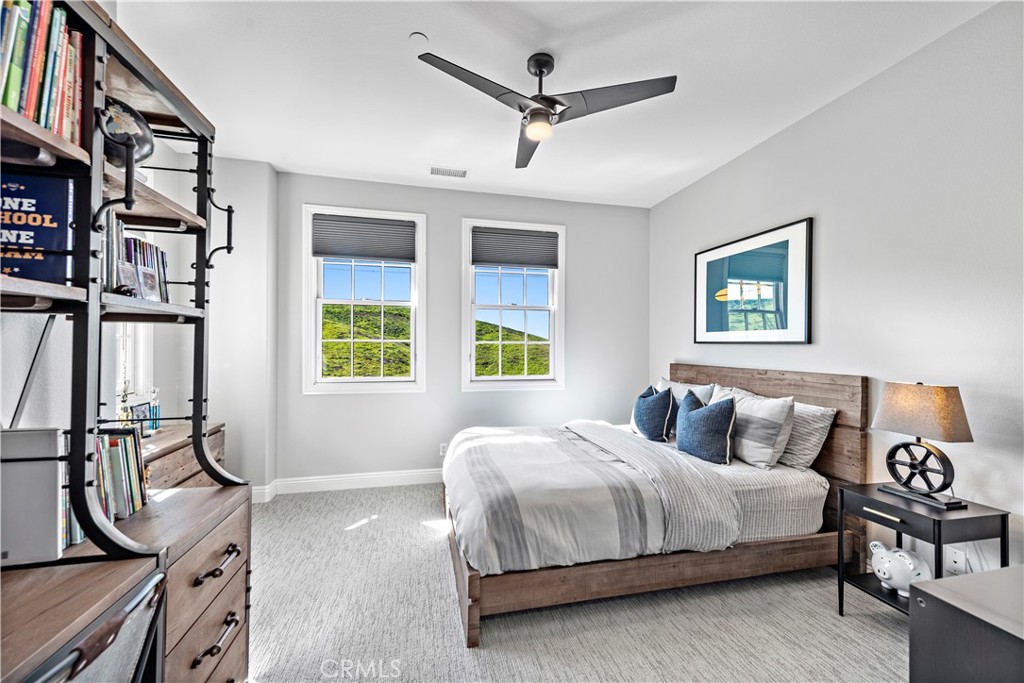 27 Pisano Street Ladera Ranch, CA 92694 - Photo 42 of 71 a bedroom with a bed dresser and a window
