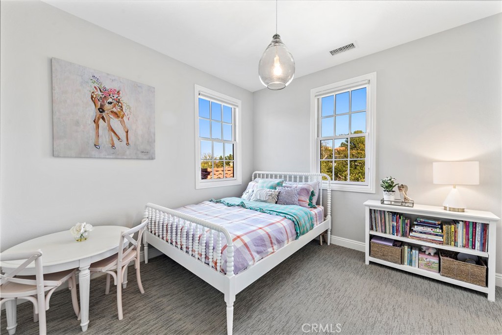 27 Pisano Street Ladera Ranch, CA 92694 - Photo 43 of 71 a bedroom with a bed bookshelf and a window