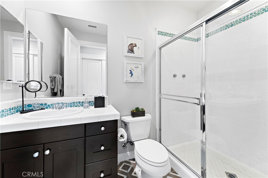 27 Pisano Street Ladera Ranch, CA 92694 - Photo 46 of 71 a bathroom with a sink vanity mirror and toilet