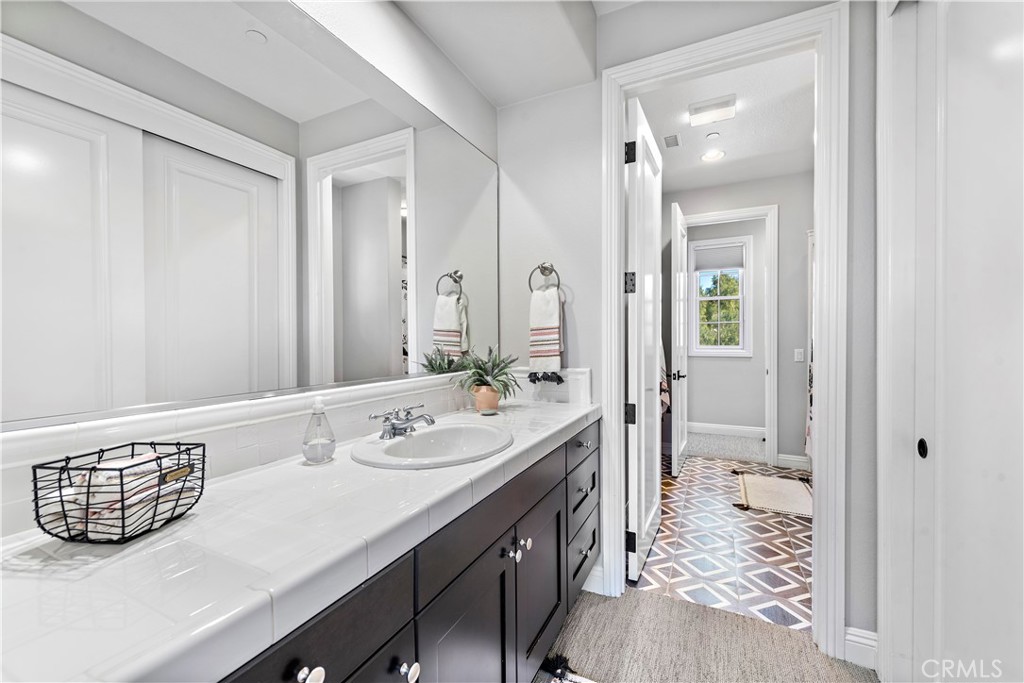 27 Pisano Street Ladera Ranch, CA 92694 - Photo 47 of 71 a bathroom with a sink a mirror and a shower