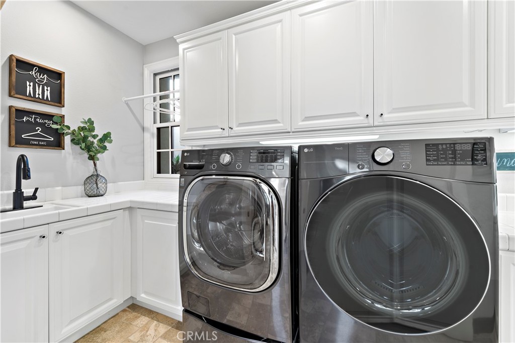 27 Pisano Street Ladera Ranch, CA 92694 - Photo 50 of 71 a utility room with sink dryer and washer