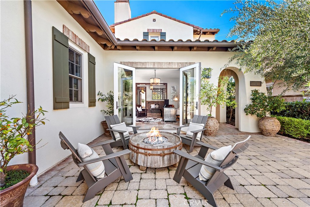 27 Pisano Street Ladera Ranch, CA 92694 - Photo 54 of 71 a view of a patio with table and chairs potted plants and a large tree