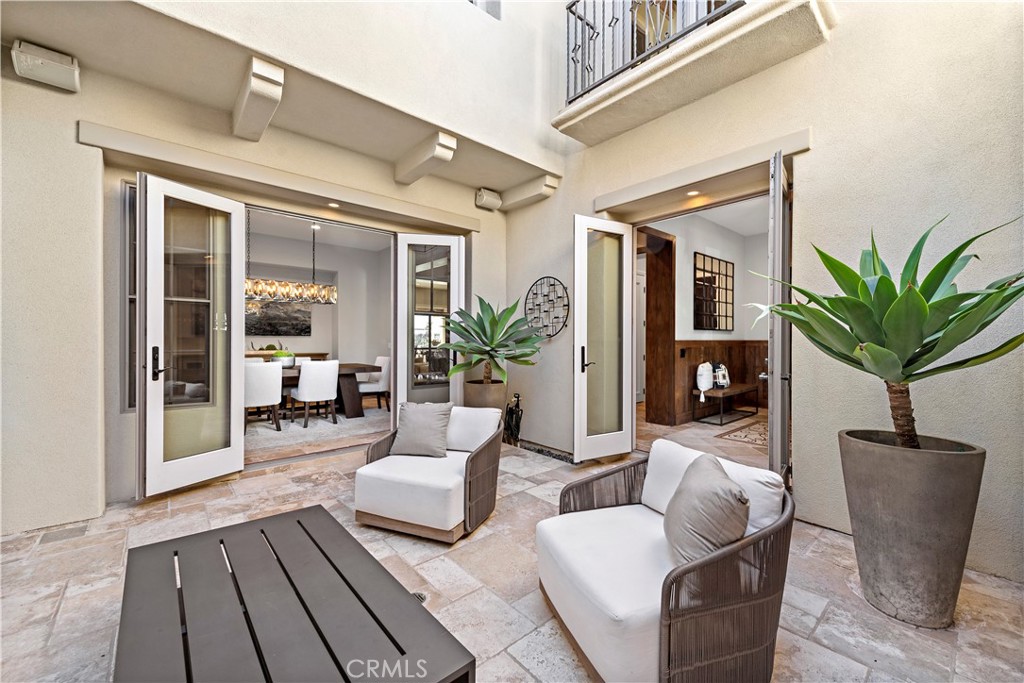 27 Pisano Street Ladera Ranch, CA 92694 - Photo 7 of 71 a living room with furniture potted plant and a floor to ceiling window